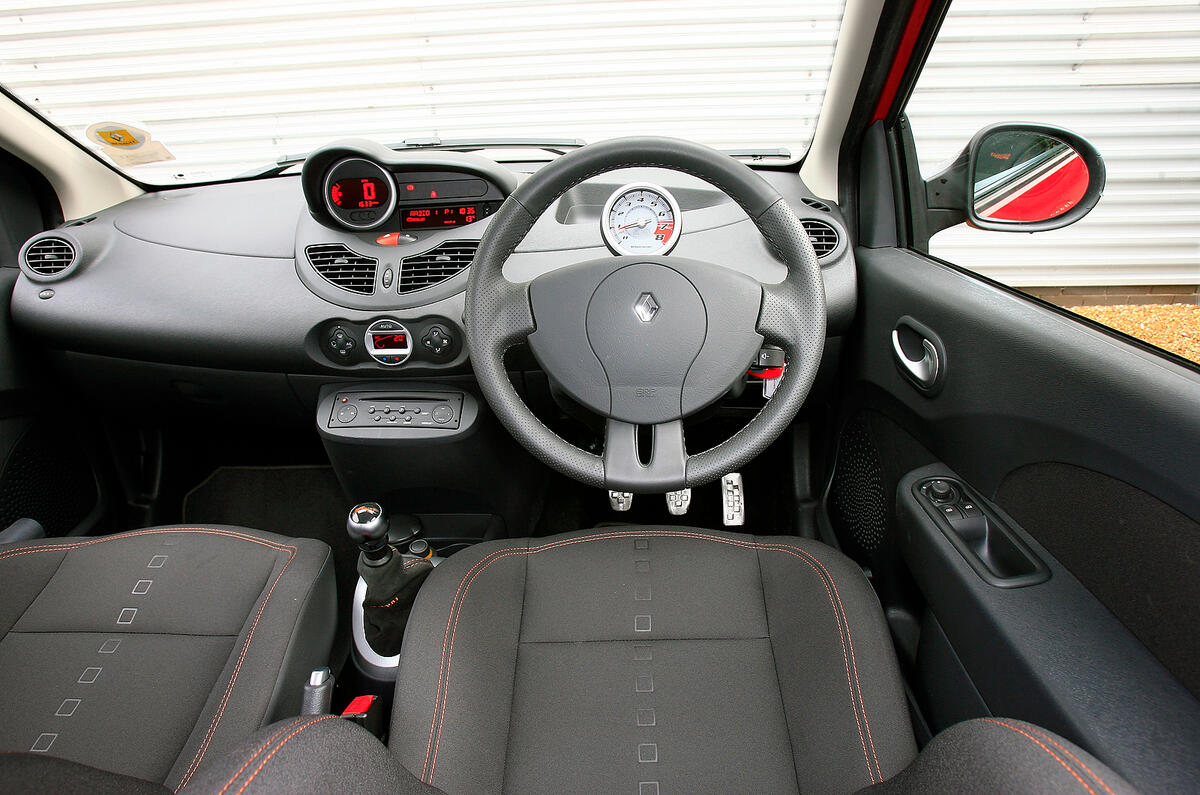 The interior features dull, dark architecture with parts-bin switchgear Renault Twingo RS133 dashboard