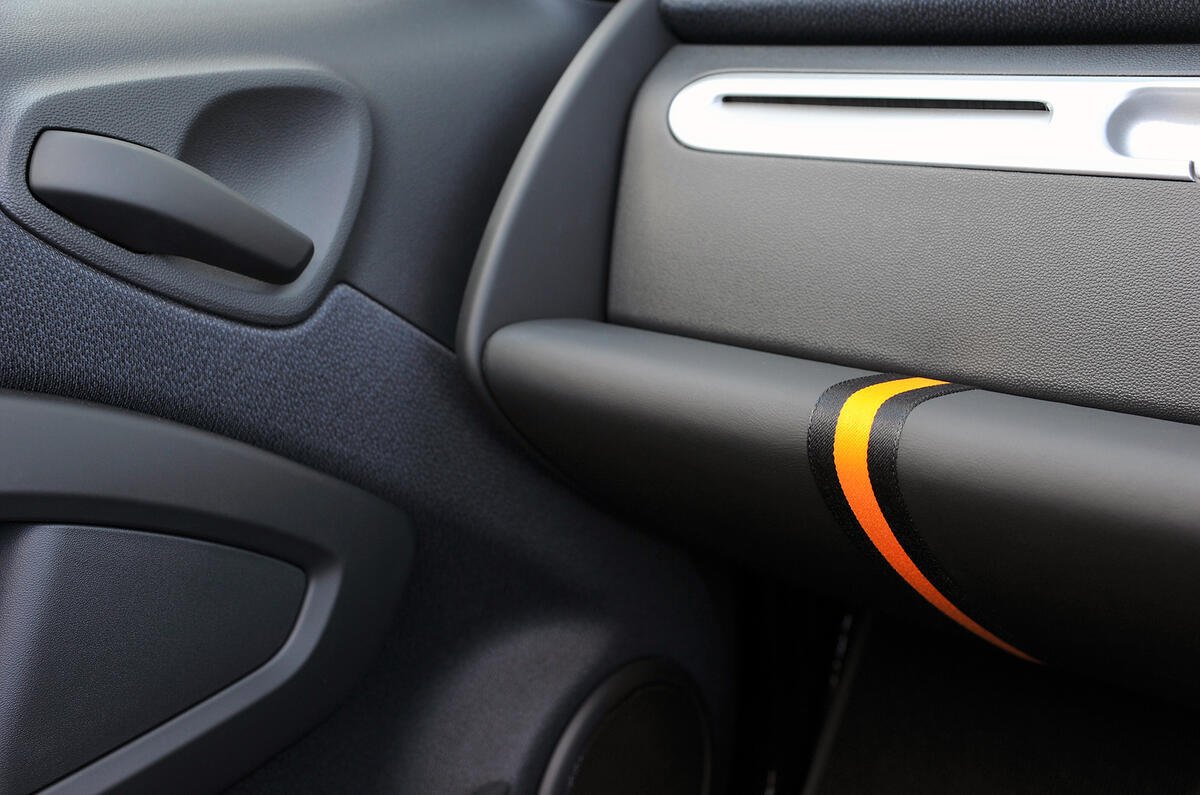 There are some cheap plastics in the ForTwo, not least around the door handle and arm rest Smart Fortwo cheap plastic dashboard