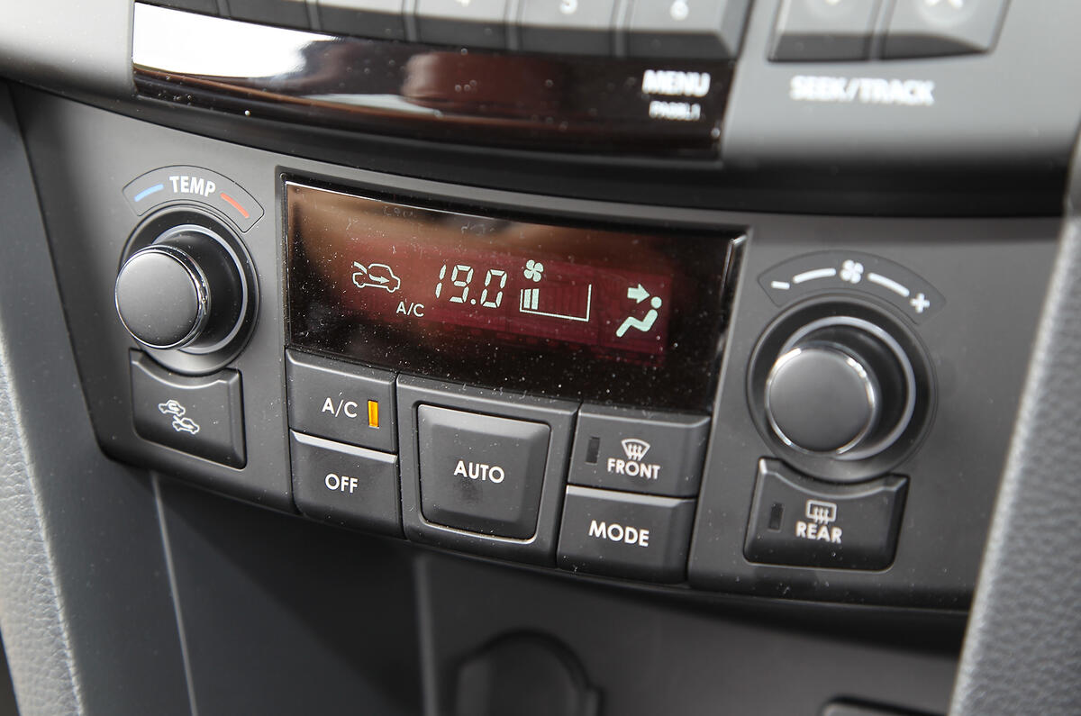 The dashboard is moulded from unappealing, hard grey plastic Suzuki Swift climate control switchgear