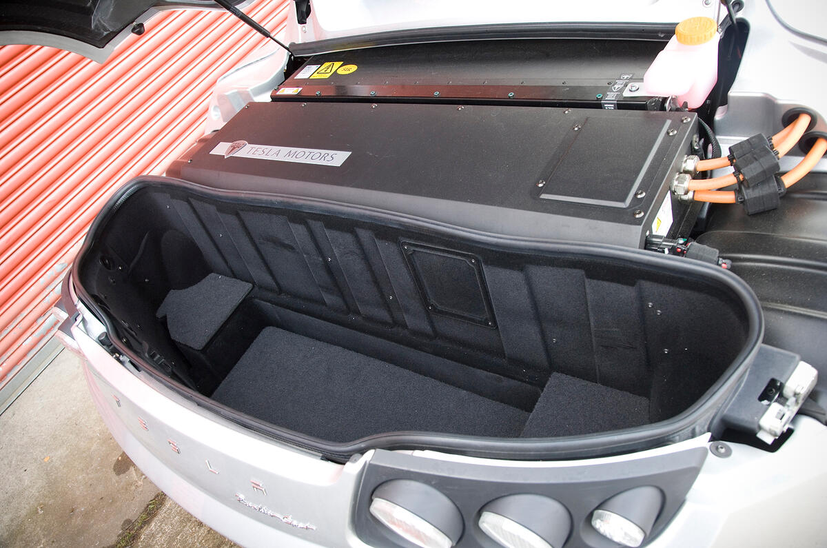 With no storage space up front, you’ll have to stick your weekend luggage here Tesla Roadster boot space