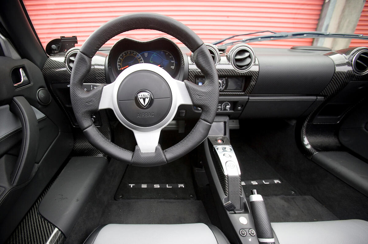 The Tesla shares the dashboard, steering wheel, windscreen and canvas roof with the Elise Tesla Roadster dashboard