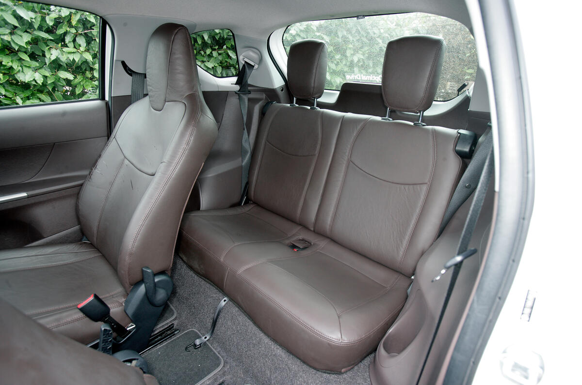 An adult can fit behind the front passenger, but it’s kids only behind the driver Toyota iQ rear seats