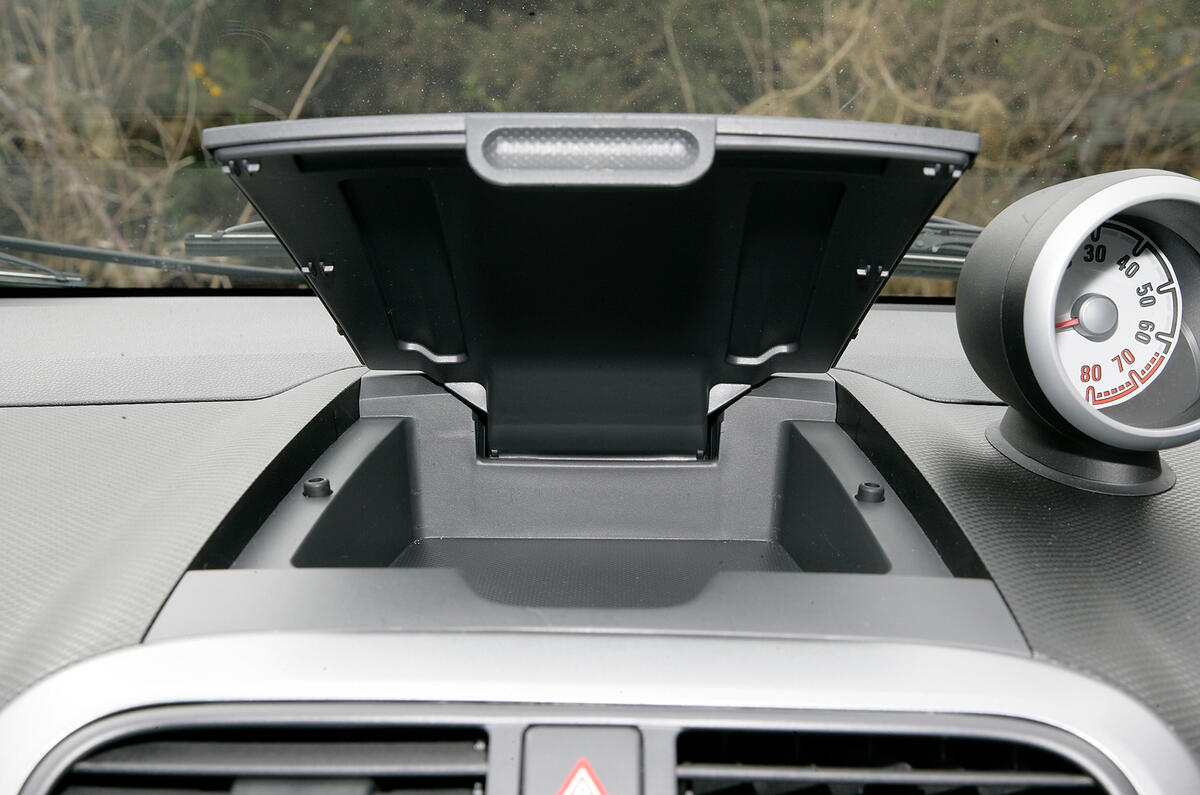 Interior storage is so-so, there’s a small cubby on the dash and alleged bottle holders in the door bin Vauxhall Agila cubby hole